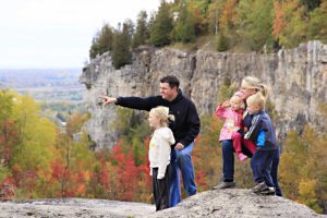 Family looking out at view of escarpment in fall at Kelso Conservation Area