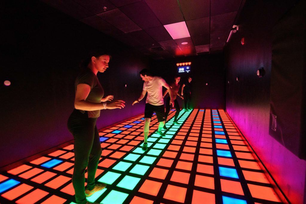 people playing activate with light up squares
