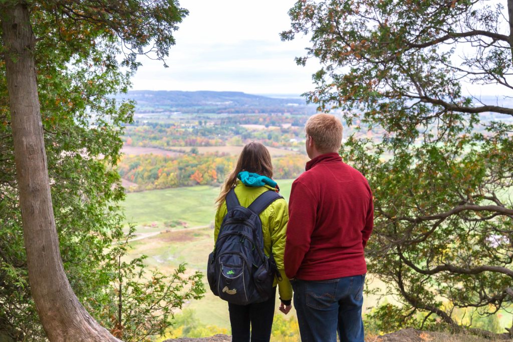 Couple looking at view of escarpment